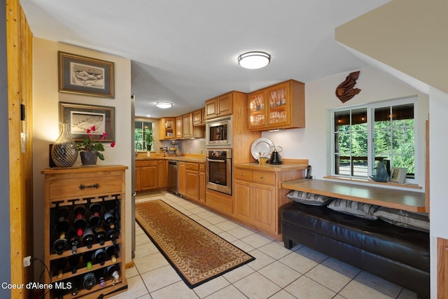 343 W Spring Creek Rd, Hope, ID 83836 - kitchen with stainless steel appliances, light tile patterned floors, glass insert cabinets, and light countertops