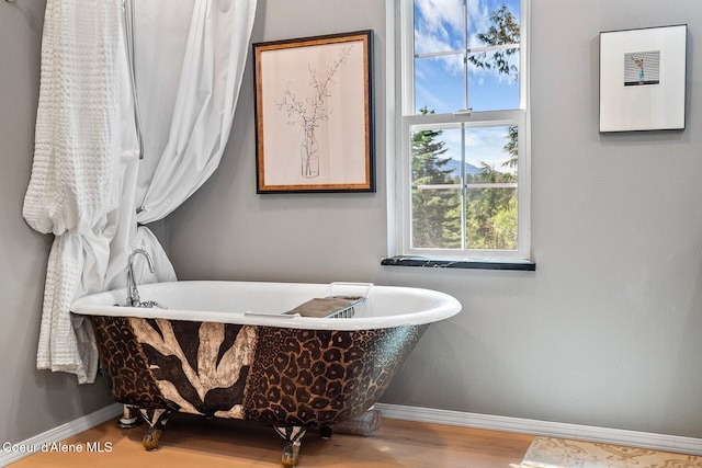 343 W Spring Creek Rd, Hope, ID 83836 - bathroom featuring baseboards, a freestanding tub, and wood finished floors