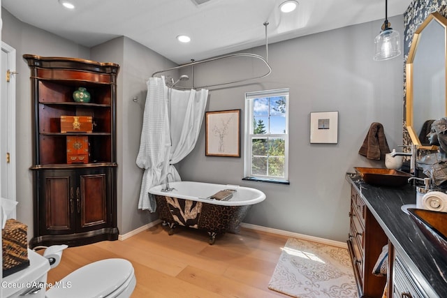 343 W Spring Creek Rd, Hope, ID 83836 - bathroom with a freestanding bath, wood finished floors, vanity, recessed lighting, and baseboards