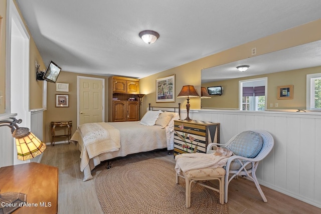 343 W Spring Creek Rd, Hope, ID 83836 - bedroom featuring light wood-style floors and wainscoting