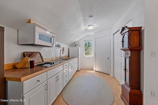 343 W Spring Creek Rd, Hope, ID 83836 - kitchen featuring white appliances, vaulted ceiling, a sink, light wood-style floors, and a textured ceiling