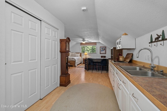 343 W Spring Creek Rd, Hope, ID 83836 - kitchen with a sink, white cabinets, light wood-style flooring, lofted ceiling, and open floor plan