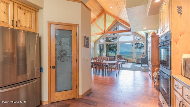 75 Windy Ln, Moyie Springs, ID 83845 - kitchen with freestanding refrigerator, lofted ceiling, hardwood / wood-style floors, baseboards, and recessed lighting