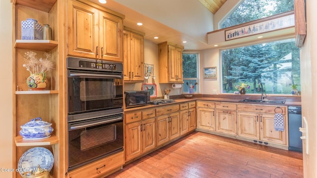 75 Windy Ln, Moyie Springs, ID 83845 - kitchen with a sink, dishwashing machine, light wood-style floors, vaulted ceiling, and stainless steel gas stovetop