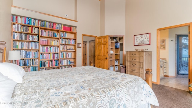 75 Windy Ln, Moyie Springs, ID 83845 - tiled bedroom with a high ceiling, carpet floors, and baseboards