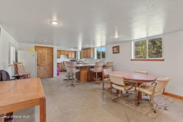 26277 N Chevrolane Way, Rathdrum, ID 83858 - dining space with a textured ceiling, recessed lighting, and concrete floors
