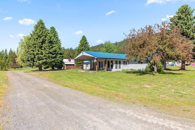 26277 N Chevrolane Way, Rathdrum, ID 83858 - ranch-style home with a front yard and driveway