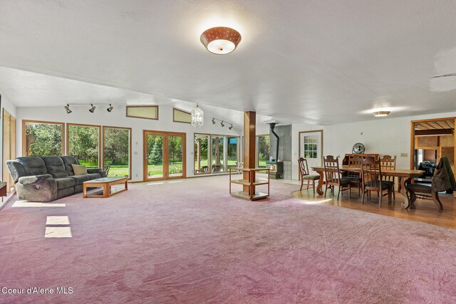26277 N Chevrolane Way, Rathdrum, ID 83858 - carpeted living room featuring plenty of natural light and vaulted ceiling