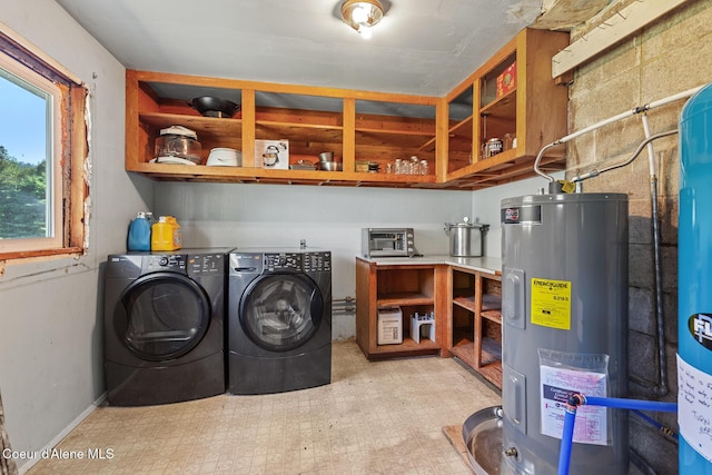 26277 N Chevrolane Way, Rathdrum, ID 83858 - washroom featuring water heater, washing machine and clothes dryer, and tile patterned floors