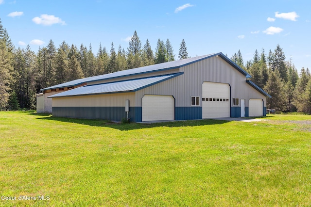 26277 N Chevrolane Way, Rathdrum, ID 83858 - view of property exterior featuring a garage, a lawn, an outbuilding, and a metal roof