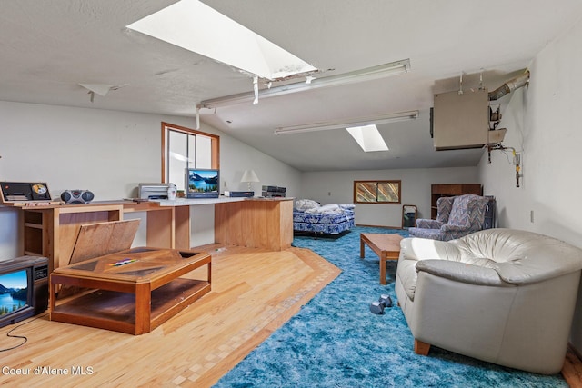 26277 N Chevrolane Way, Rathdrum, ID 83858 - living room featuring a skylight, wood finished floors, and vaulted ceiling