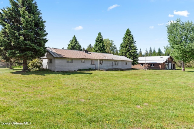 26277 N Chevrolane Way, Rathdrum, ID 83858 - rear view of property with a yard