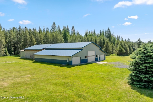 26277 N Chevrolane Way, Rathdrum, ID 83858 - view of pole building with a yard and a wooded view