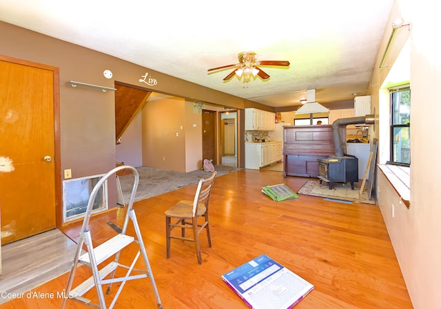 464 E Lincoln, Priest River, ID 83856 - dining area featuring a wood stove, light wood finished floors, and a ceiling fan
