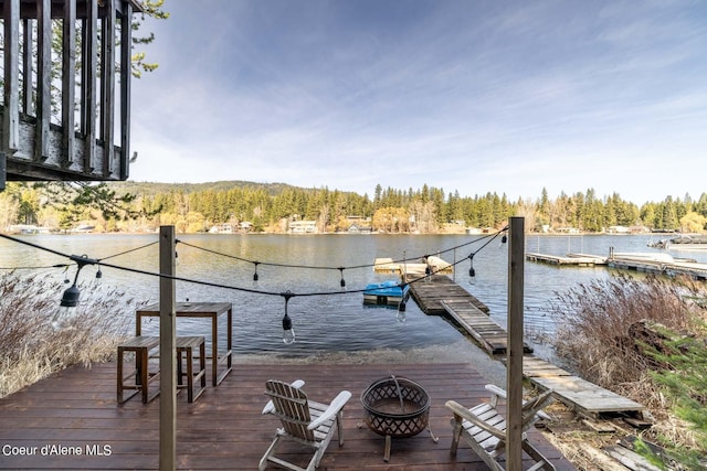 7771 W Channel Ln, Rathdrum, ID 83858 - dock area featuring a water view, a view of trees, and a fire pit