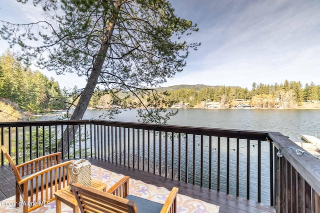 7771 W Channel Ln, Rathdrum, ID 83858 - wooden terrace featuring a water view and a forest view