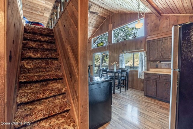 7771 W Channel Ln, Rathdrum, ID 83858 - stairway with wood ceiling, wood walls, wood finished floors, and high vaulted ceiling