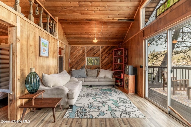 7771 W Channel Ln, Rathdrum, ID 83858 - living room with lofted ceiling, wood ceiling, wood walls, healthy amount of natural light, and wood finished floors