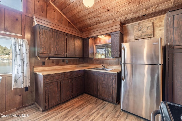 7771 W Channel Ln, Rathdrum, ID 83858 - kitchen featuring freestanding refrigerator, a sink, vaulted ceiling, wooden ceiling, and light countertops