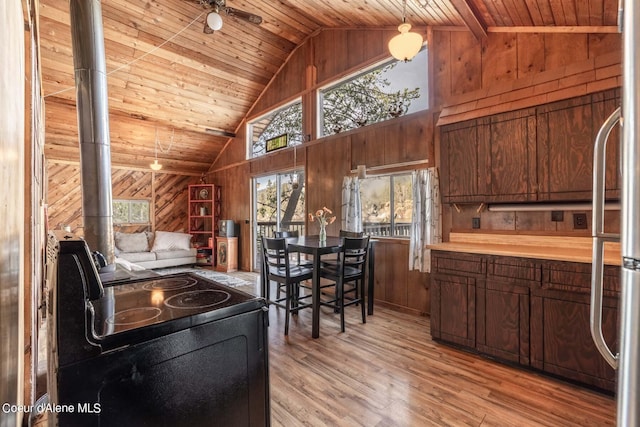7771 W Channel Ln, Rathdrum, ID 83858 - kitchen with wood walls, electric range, wood ceiling, refrigerator, and light wood-type flooring