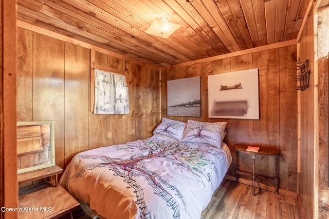 7771 W Channel Ln, Rathdrum, ID 83858 - bedroom with wood ceiling, wood walls, and hardwood / wood-style floors