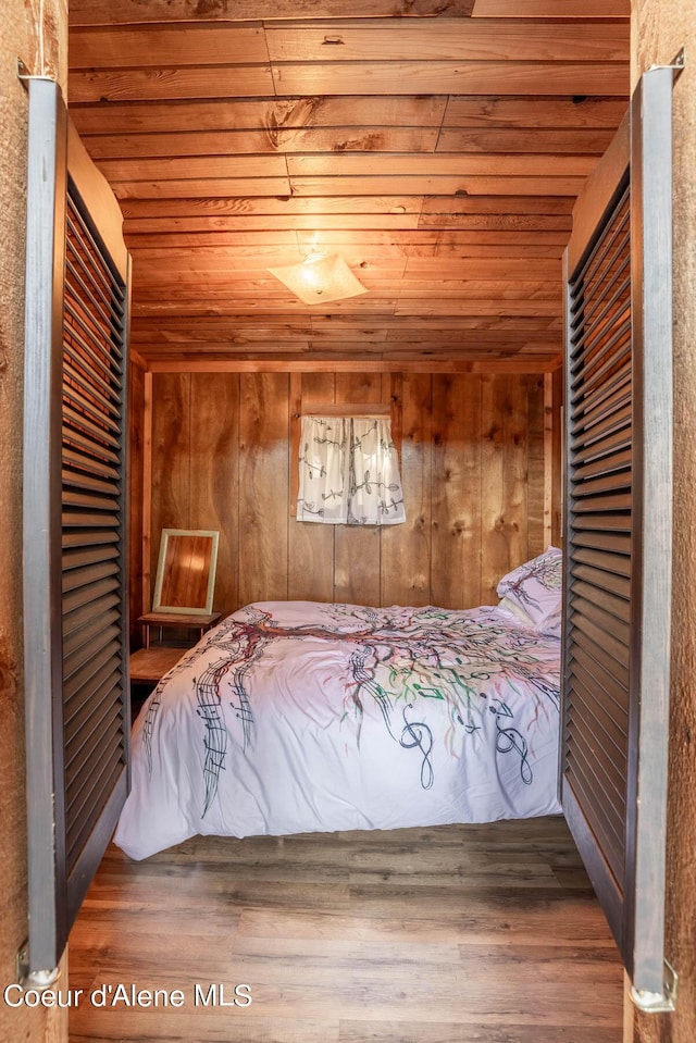 7771 W Channel Ln, Rathdrum, ID 83858 - bedroom with wood ceiling, wooden walls, and wood finished floors
