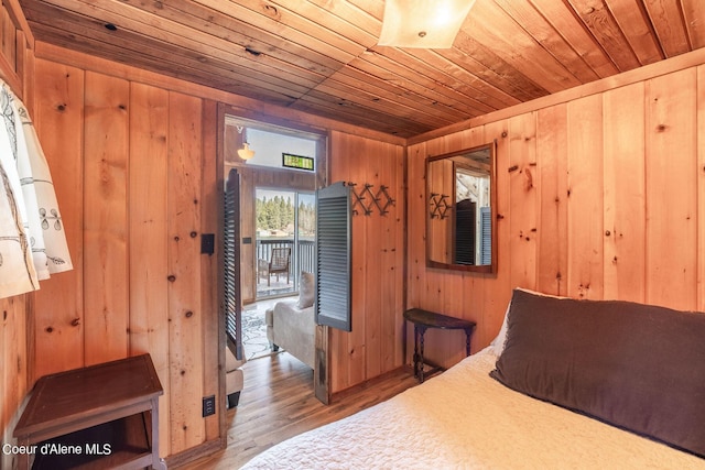 7771 W Channel Ln, Rathdrum, ID 83858 - bedroom featuring wooden ceiling, wooden walls, and wood finished floors
