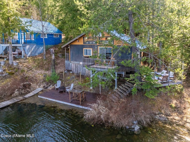 7771 W Channel Ln, Rathdrum, ID 83858 - rear view of house featuring a deck with water view