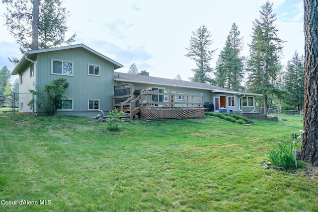 7672 W Carnie Rd, Coeur Dalene, ID 83814 - back of house with a deck and a chimney