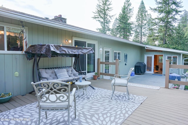 7672 W Carnie Rd, Coeur Dalene, ID 83814 - wooden deck featuring an outdoor living space and area for grilling