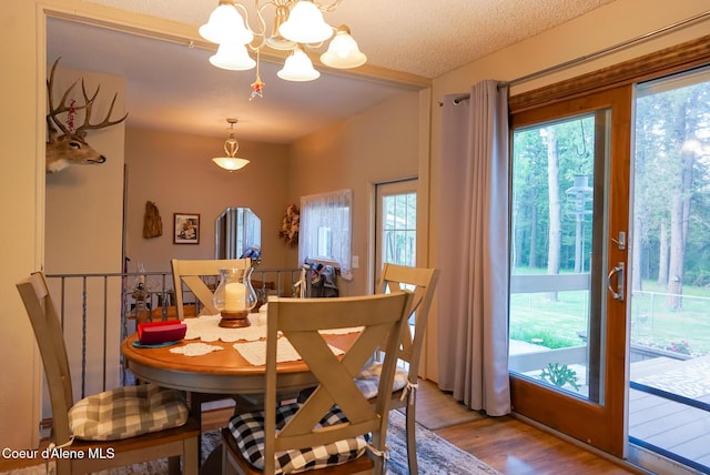 7672 W Carnie Rd, Coeur Dalene, ID 83814 - dining area featuring a chandelier and wood finished floors