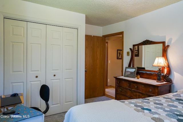 7672 W Carnie Rd, Coeur Dalene, ID 83814 - bedroom featuring a closet, carpet floors, and a textured ceiling