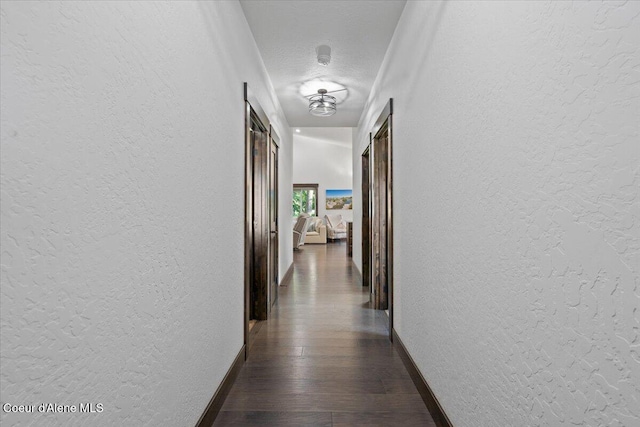 21838 N Medallist Ct, Rathdrum, ID 83858 - hallway with a textured wall, dark wood-style flooring, and a textured ceiling