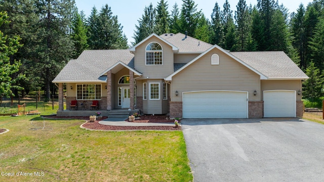 23216 E Morris Rd, Newman Lake, WA 99025 - traditional-style home featuring asphalt driveway, an attached garage, a porch, roof with shingles, and brick siding