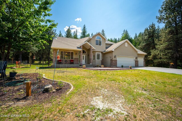 23216 E Morris Rd, Newman Lake, WA 99025 - view of front facade featuring an attached garage, asphalt driveway, a front yard, brick siding, and roof with shingles