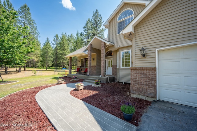 23216 E Morris Rd, Newman Lake, WA 99025 - property entrance with brick siding, a yard, and a porch