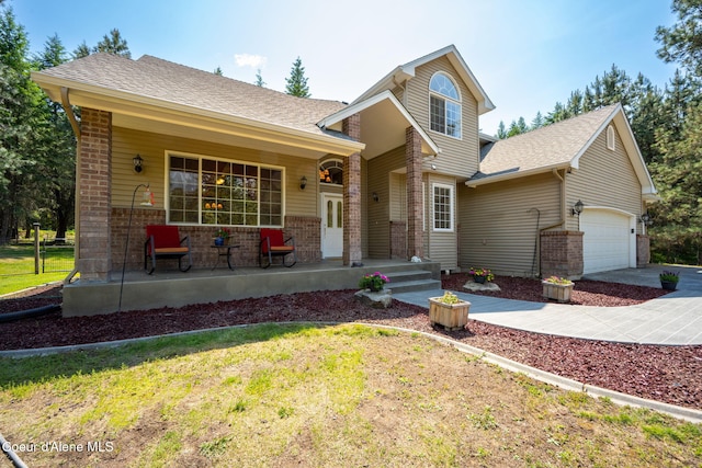 23216 E Morris Rd, Newman Lake, WA 99025 - tri-level home with covered porch, brick siding, and a garage