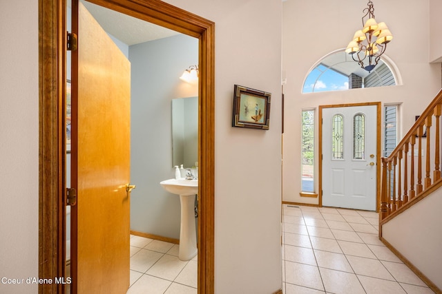 23216 E Morris Rd, Newman Lake, WA 99025 - foyer entrance with a chandelier, light tile patterned floors, stairs, and baseboards