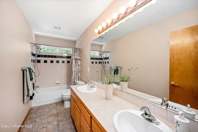 23216 E Morris Rd, Newman Lake, WA 99025 - full bathroom with double vanity, shower / tub combo with curtain, toilet, baseboards, and stone finish floors