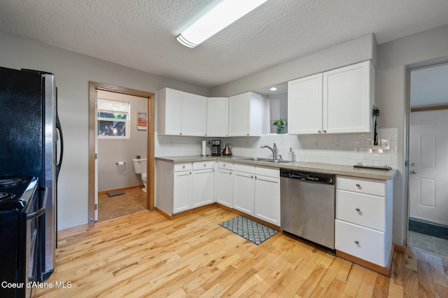 927 E Birch Ave, Coeur Dalene, ID 83814 - kitchen with stainless steel appliances, backsplash, light wood finished floors, white cabinetry, and a textured ceiling
