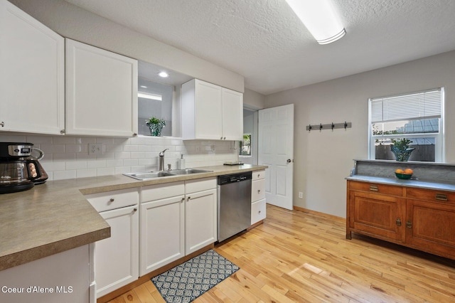 927 E Birch Ave, Coeur Dalene, ID 83814 - kitchen featuring stainless steel dishwasher, light wood-style floors, tasteful backsplash, white cabinets, and a textured ceiling