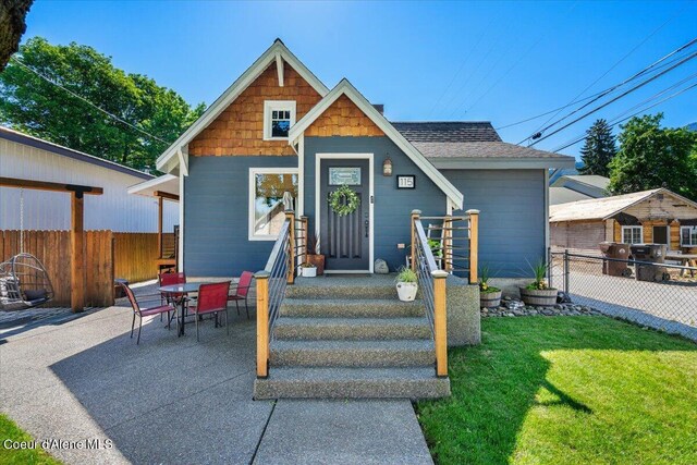 115 Fifth St, Osburn, ID 83849 - view of front of property featuring a shingled roof and a patio