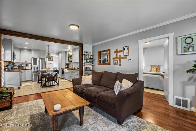 115 Fifth St, Osburn, ID 83849 - living area featuring light wood-type flooring and ornamental molding
