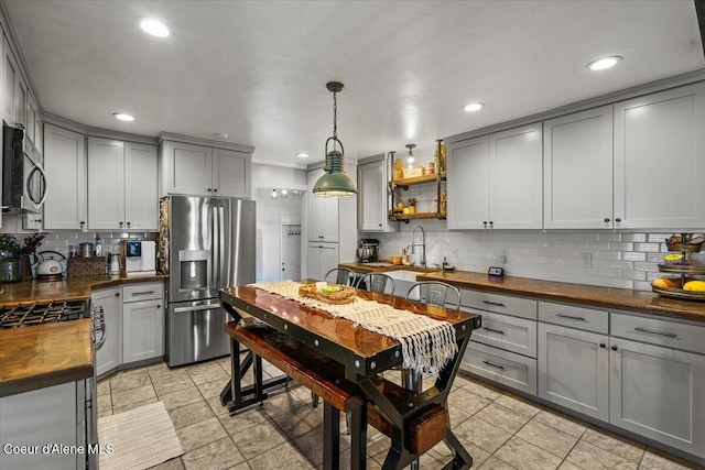 115 Fifth St, Osburn, ID 83849 - kitchen with appliances with stainless steel finishes, gray cabinets, butcher block countertops, tasteful backsplash, and recessed lighting