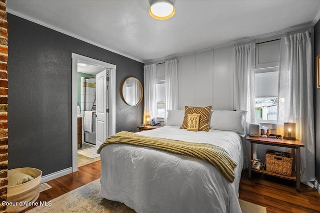 115 Fifth St, Osburn, ID 83849 - bedroom featuring ornamental molding, wood finished floors, a textured wall, baseboards, and connected bathroom