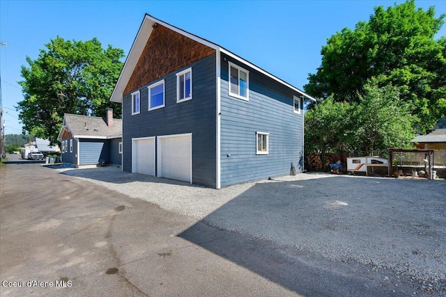 115 Fifth St, Osburn, ID 83849 - view of side of home with an attached garage and driveway