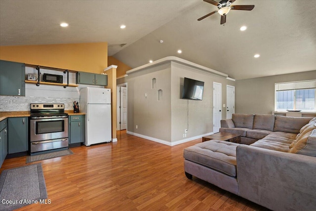 115 Fifth St, Osburn, ID 83849 - living area with lofted ceiling, light wood-type flooring, ceiling fan, recessed lighting, and baseboards
