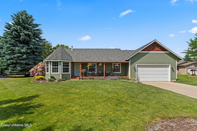67 Spur Dr, Sandpoint, ID 83864 - view of front of home with covered porch, an attached garage, concrete driveway, and a front lawn