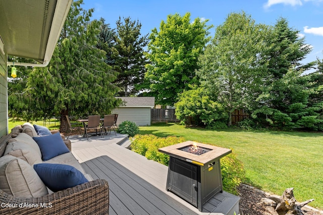 67 Spur Dr, Sandpoint, ID 83864 - deck with a fire pit, outdoor dining space, and an outbuilding
