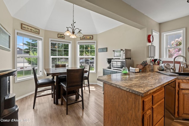 67 Spur Dr, Sandpoint, ID 83864 - dining space with a chandelier, light wood finished floors, healthy amount of natural light, and lofted ceiling
